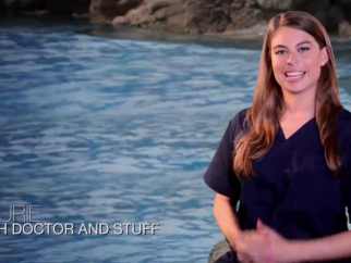 A woman sitting in front of water. Text in the bottom left corner says "Laurie: Fish doctor and stuff"